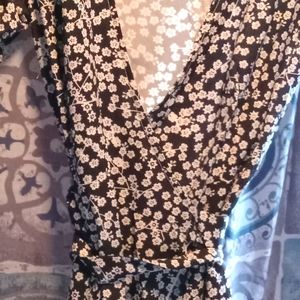 Wrap dress short slightly puffy sleeves.Black and white flower design flirty